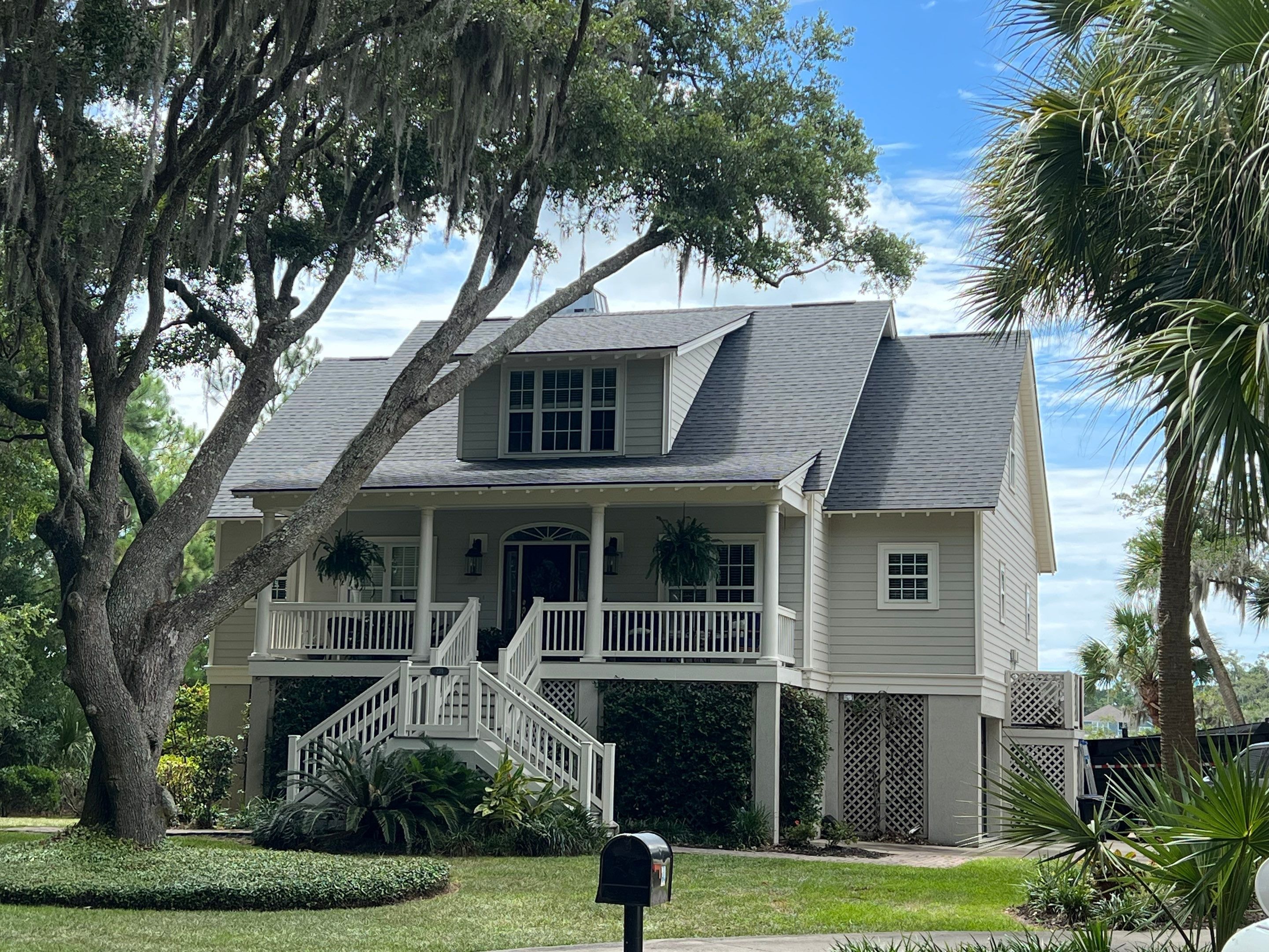 Completed roof replacement on coastal South Carolina home with oak trees