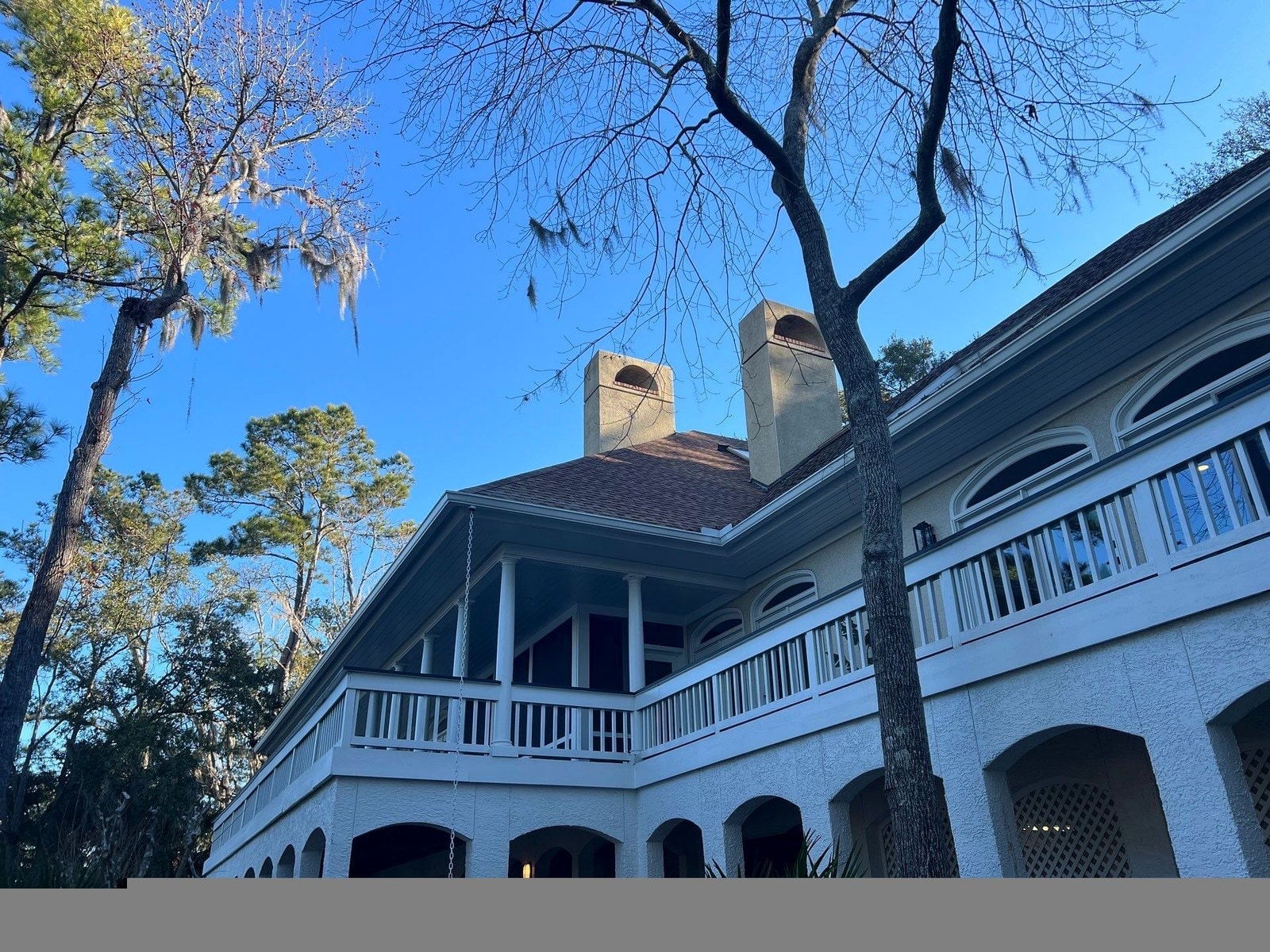 Completed roof replacement on blue colonial home in Hilton Head Island SC