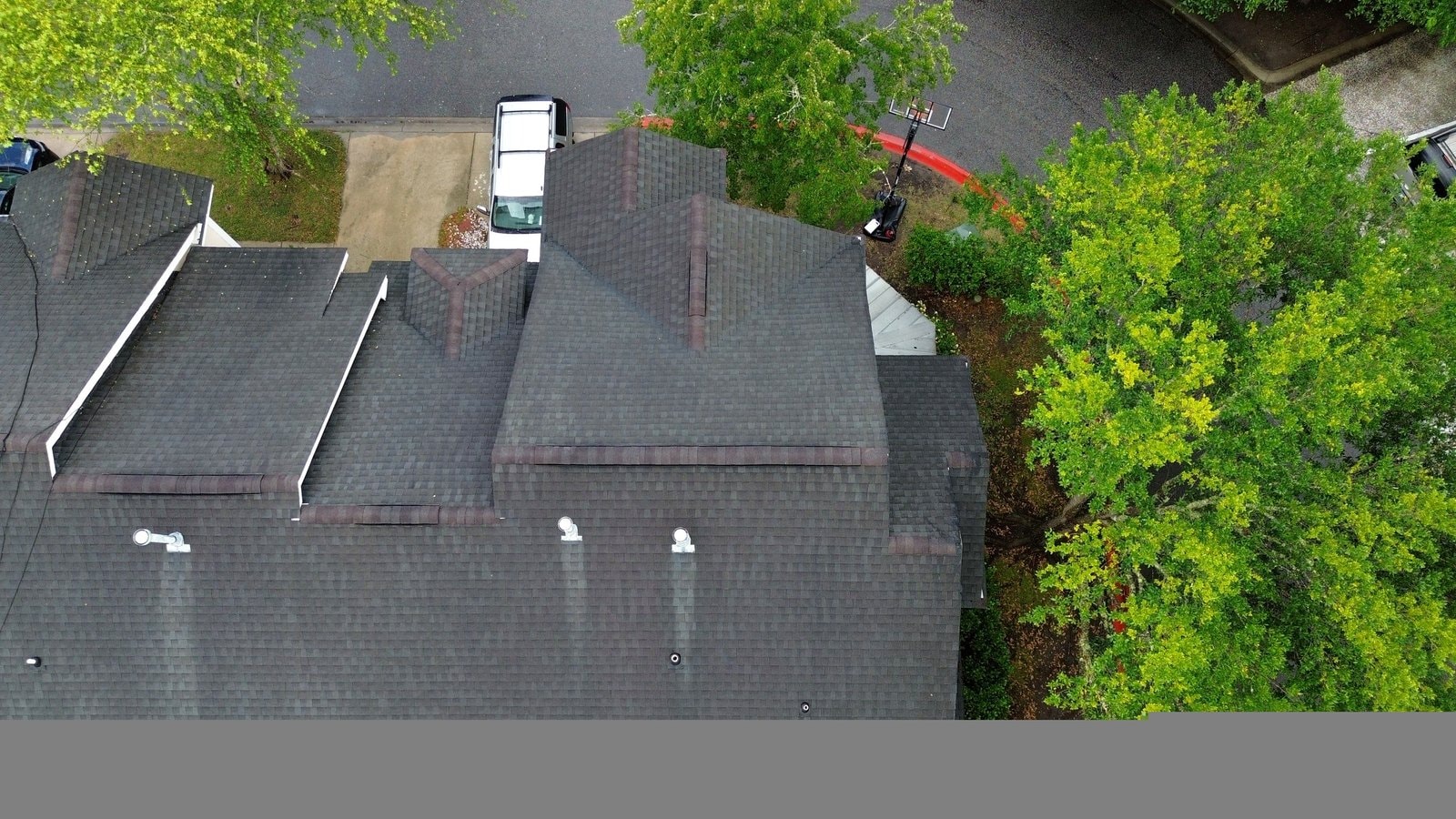 Aerial view of completed roof replacement in Bluffton SC with crew truck