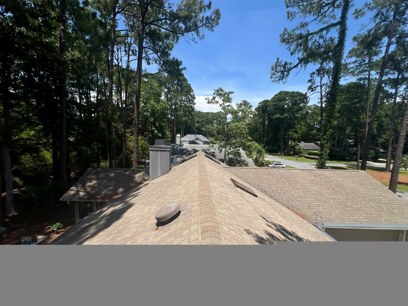 Completed roof replacement surrounded by tall trees in Hilton Head Island SC